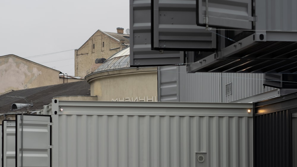 a row of shipping containers sitting on top of a roof