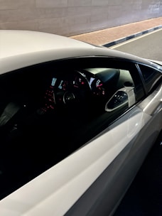 Close-up of a calm driving instructor explaining controls to a student.
