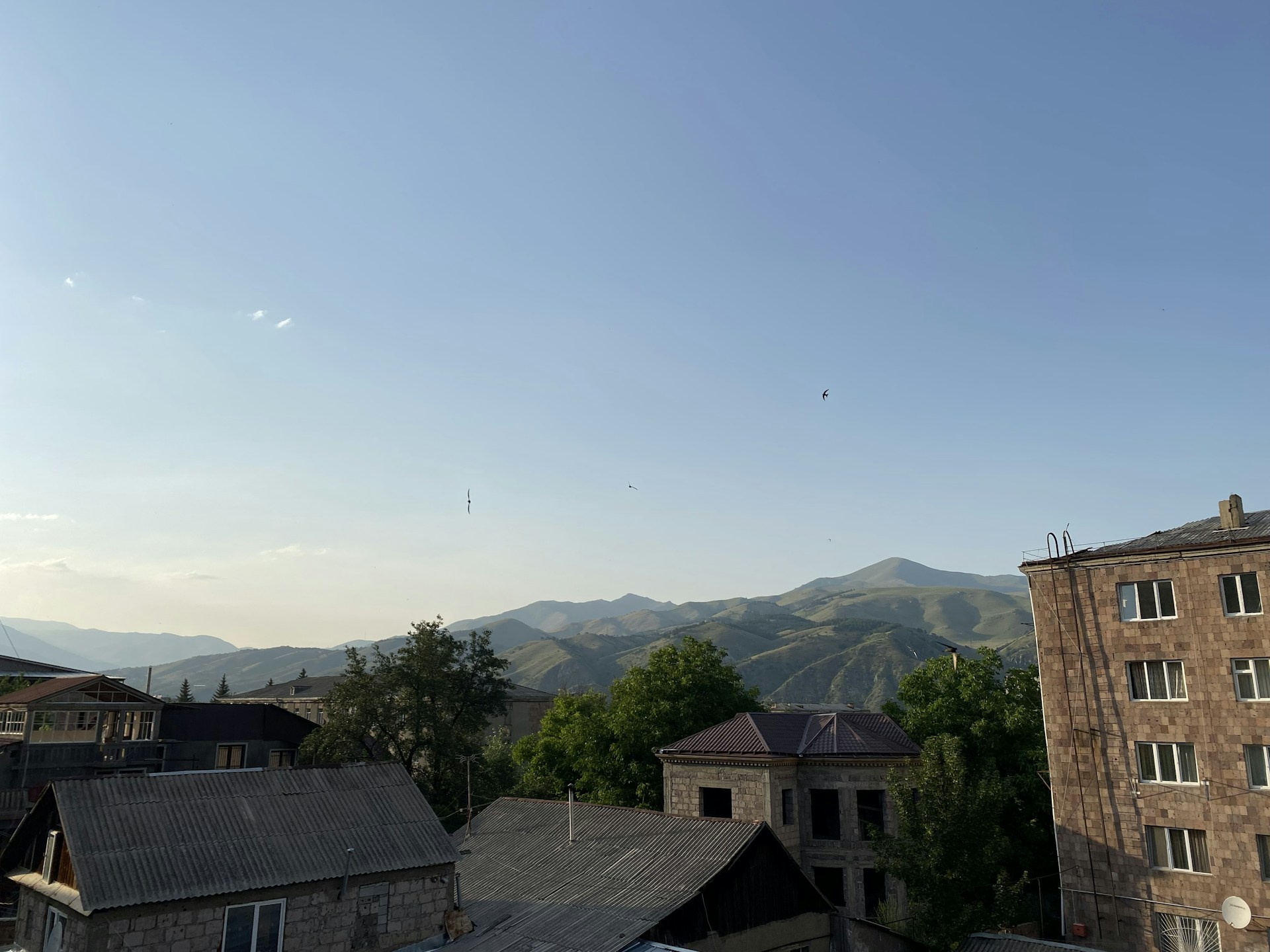 woman wearing yellow long-sleeved dress under white clouds and blue sky during daytime