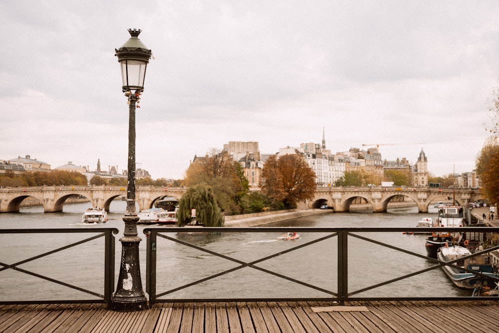 a view of a bridge over a river with boats on it