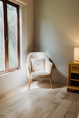 Cozy corner with stylish armchair and soft lighting.