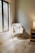 A warm and inviting living room with a cozy chair and soft lighting, perfect for relaxation and bonding with a newborn.