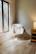 A cozy, inviting room with a comfortable chair and warm lighting.