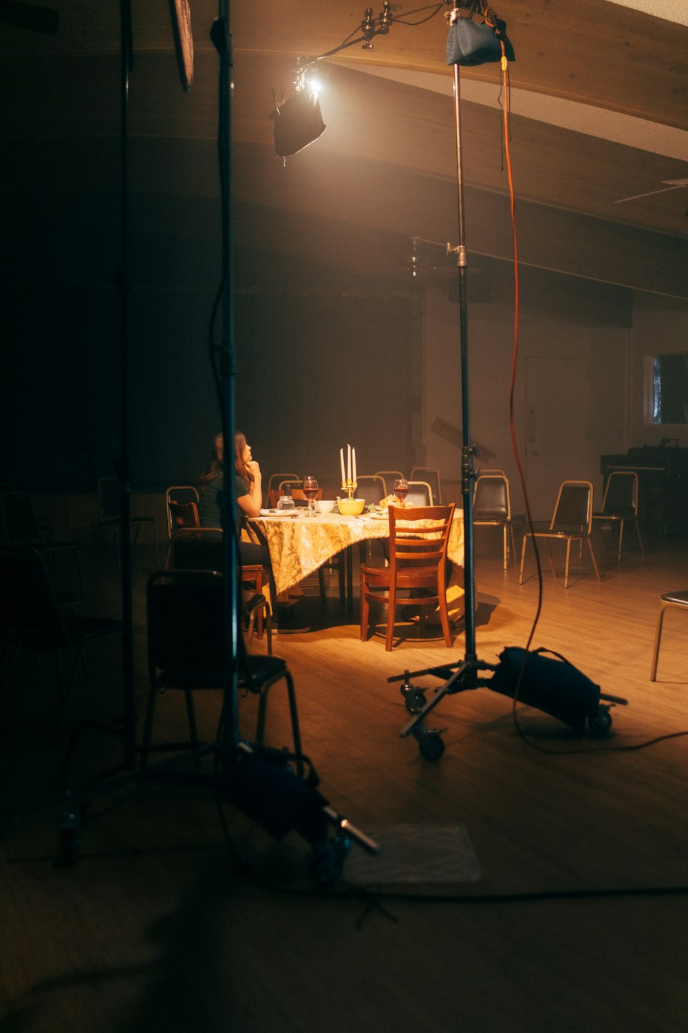 a room with a table, chairs, and lights in it