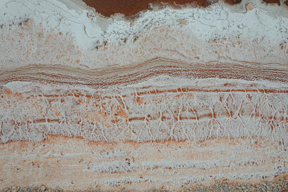 an aerial view of a sandy beach with waves