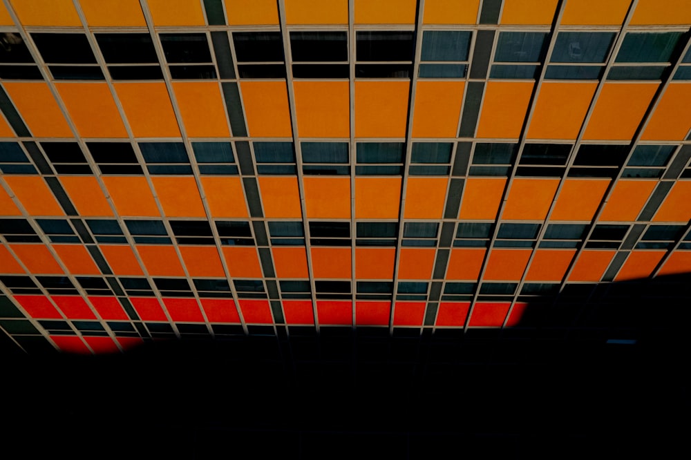 an orange and black tiled ceiling in a building