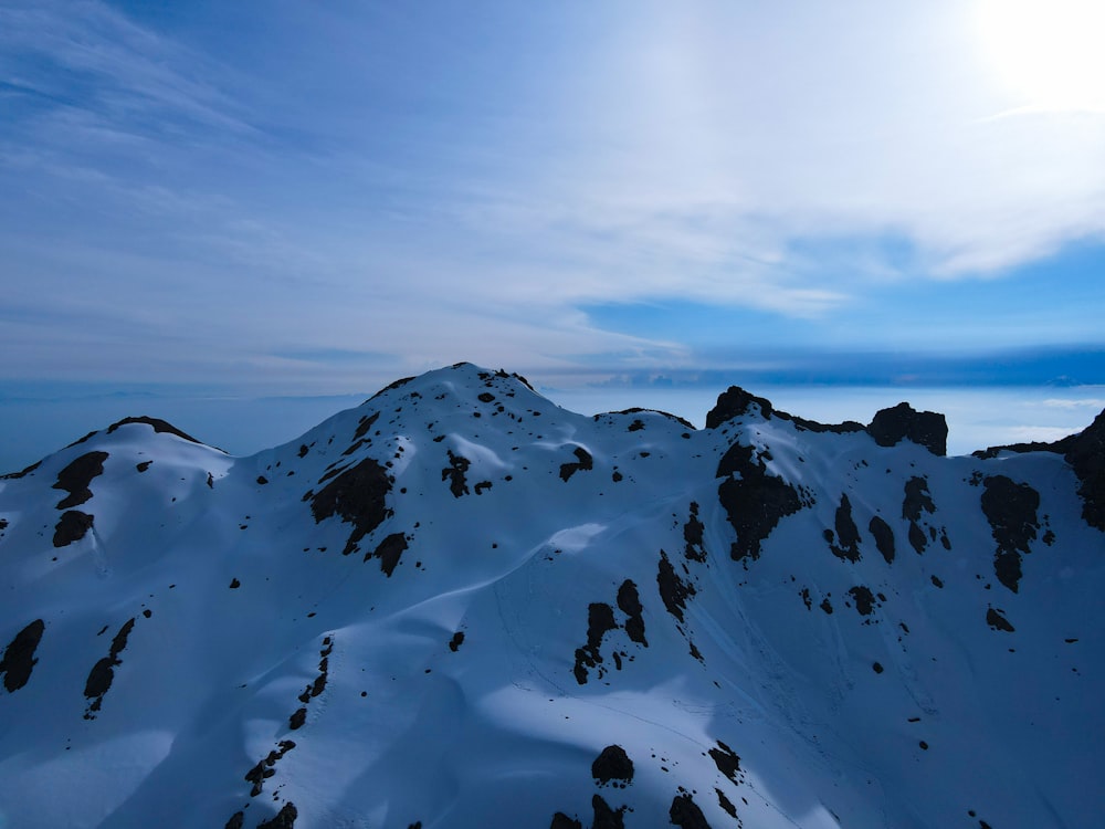 a mountain covered in snow under a blue sky