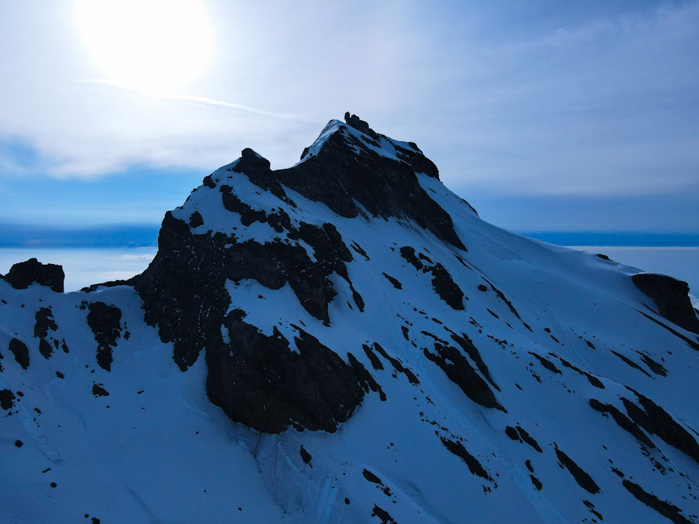 a mountain covered in snow under a blue sky