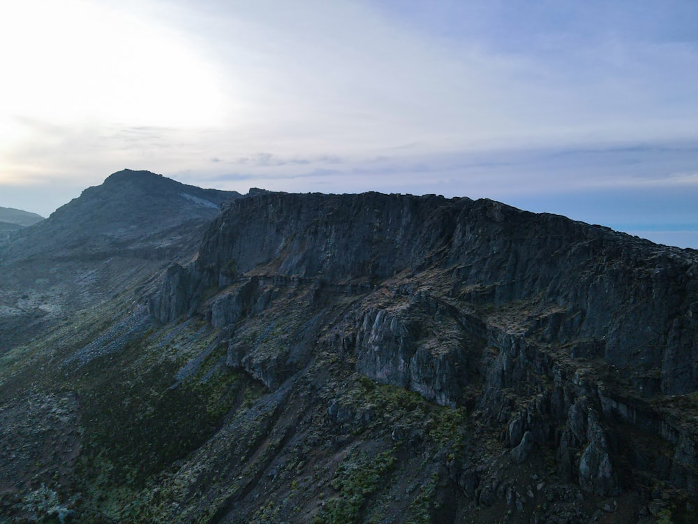 a very tall mountain with a sky background