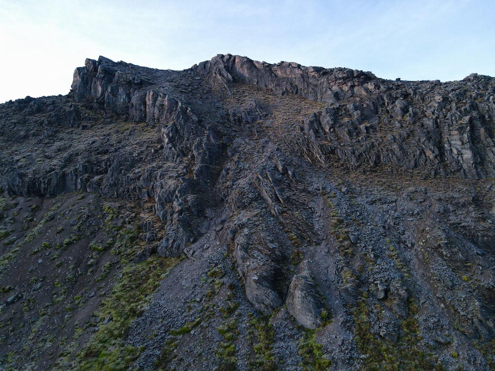 a very tall rocky mountain with a sky background