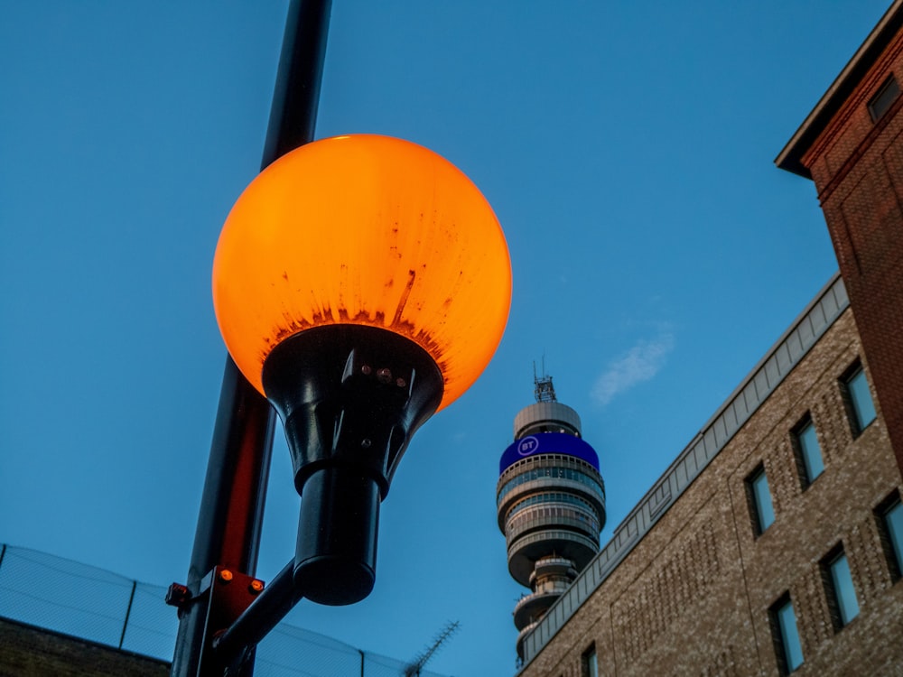 a street light with a building in the background