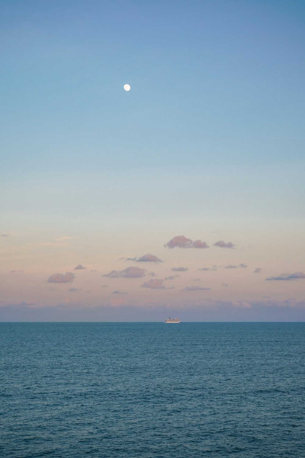 a large body of water with a boat in the distance