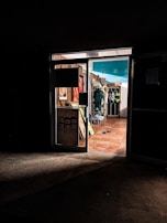 The storefront of Terminal 5 Hats and Caps with a welcoming entrance and hats displayed in the window.