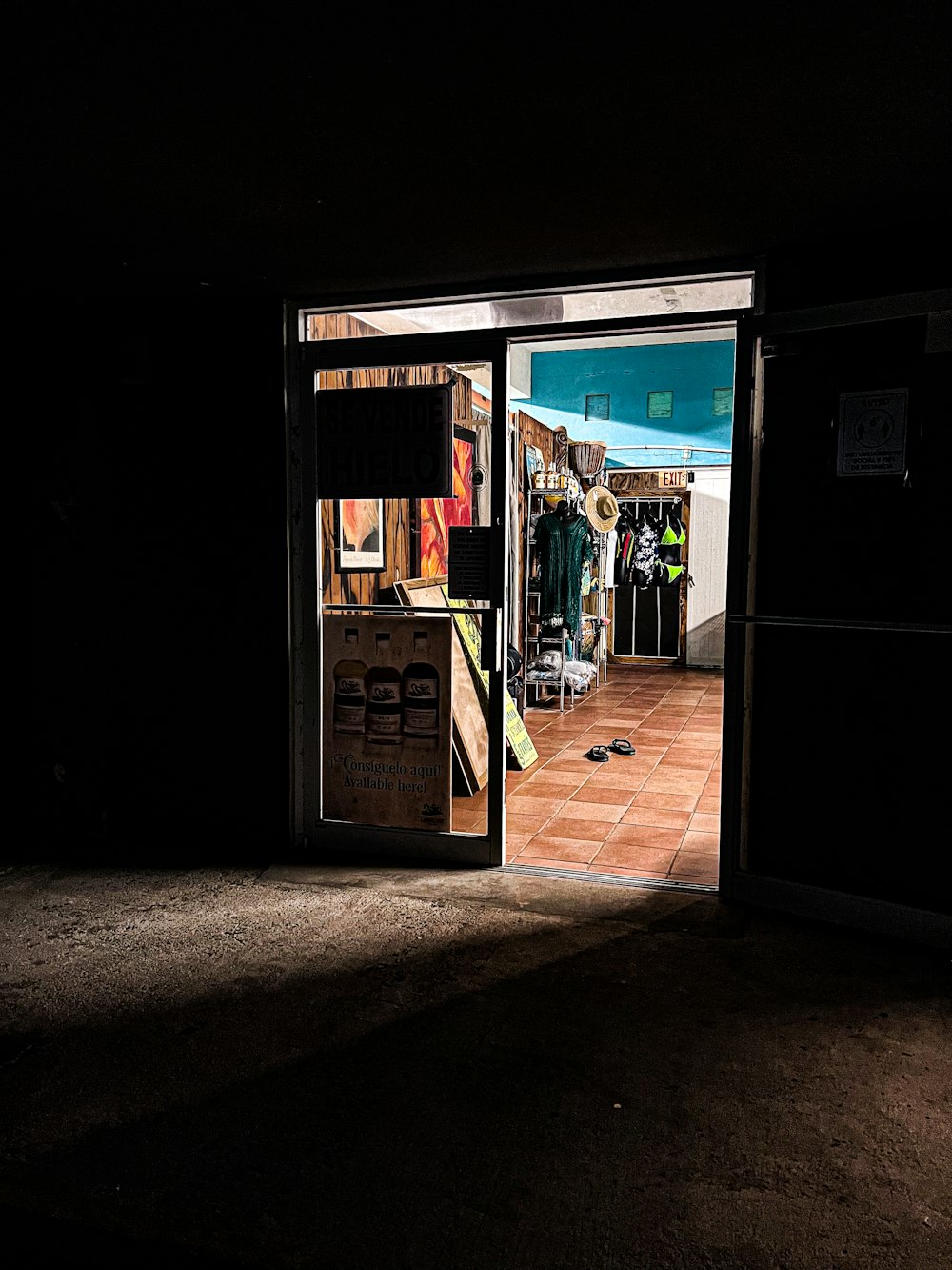 an open door to a dark room with a skateboard on the floor