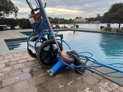 Swimming pool cleaning equipment and accessories arranged neatly