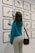 a woman taking a picture of a wall with birds on it