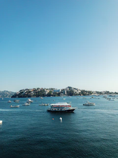a group of boats floating on top of a large body of water