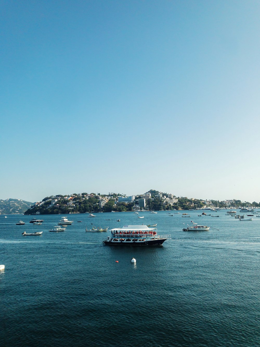 a group of boats floating on top of a large body of water