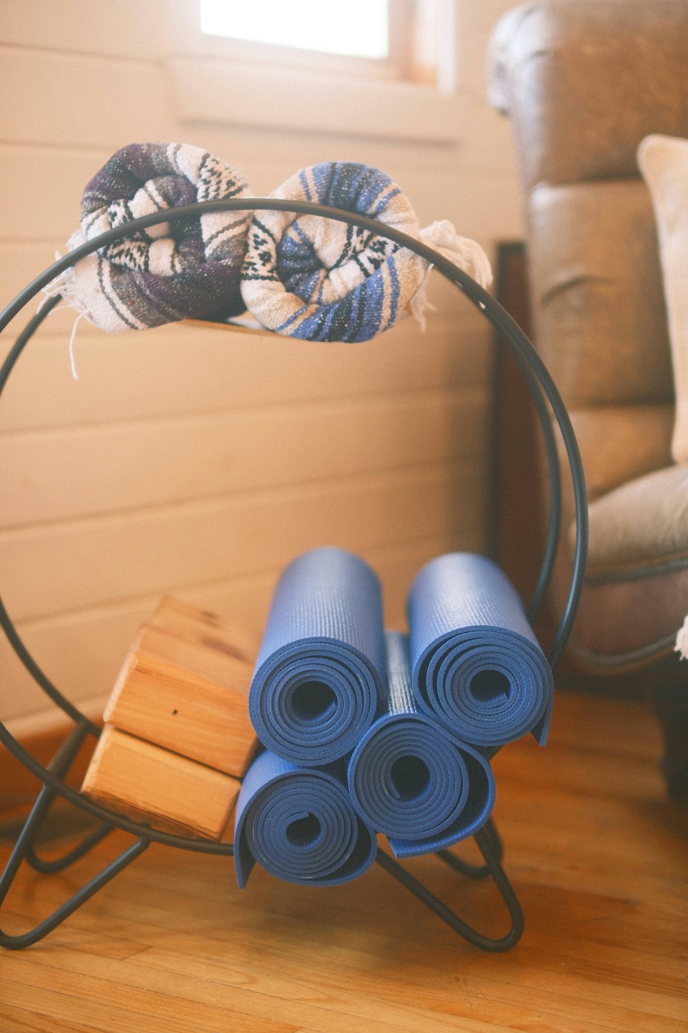 a couple of blue yoga mats sitting on top of a wooden floor