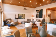 Before and after shots of a living room transformed with fresh paint and updated lighting.