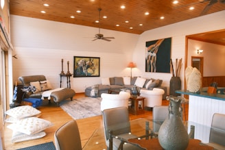 A well-lit living room featuring comfortable seating and art.