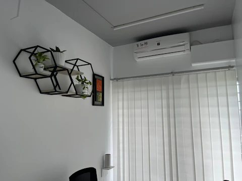Modern office space with a solar-powered air conditioner mounted on the wall.
