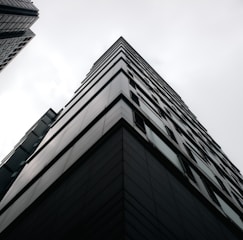 A sleek, high-definition photograph showcasing a contemporary London building with glass, concrete, and steel elements under soft natural light.