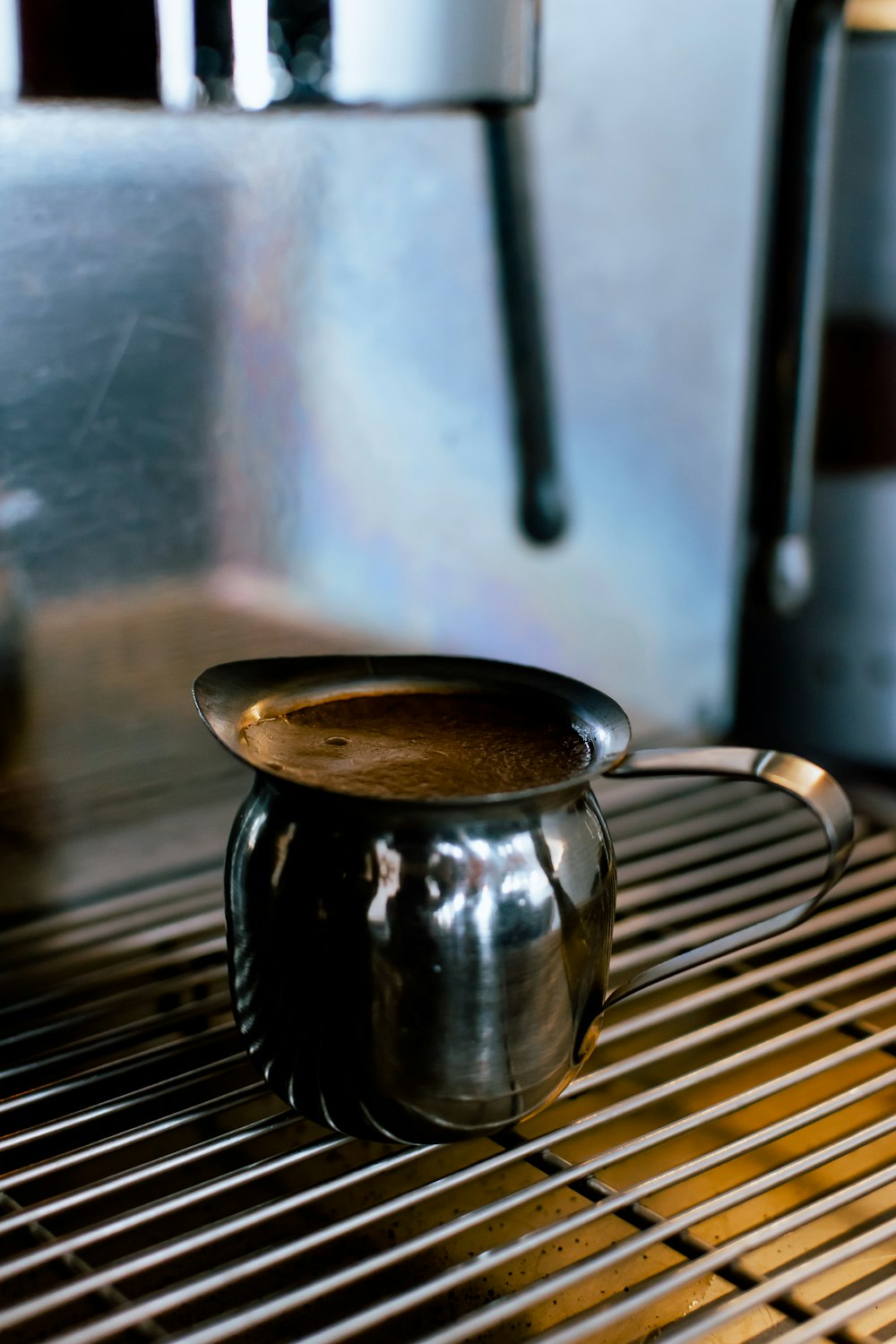 a coffee pot sitting on top of a grill