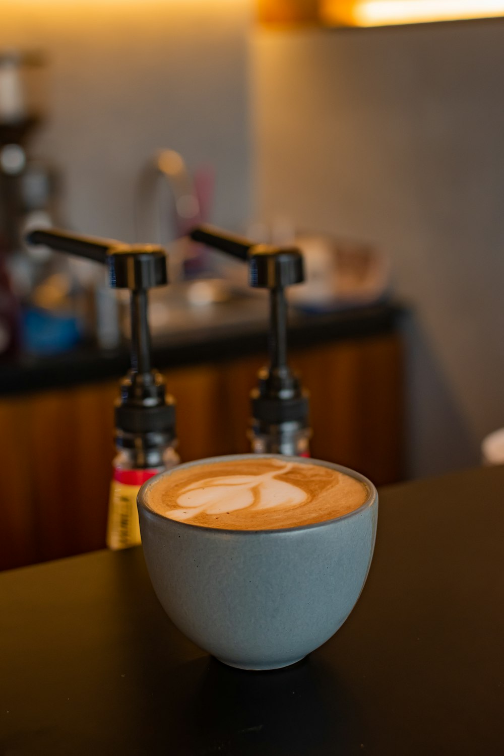 a cup of coffee sitting on top of a counter