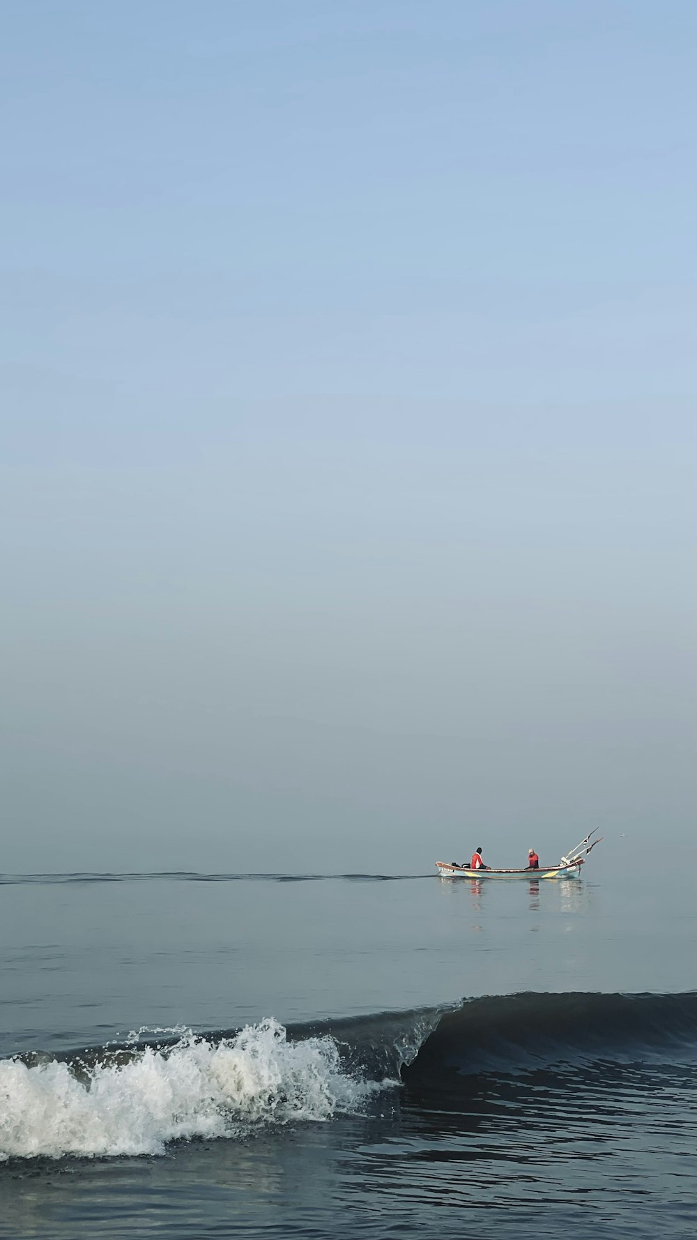 a small boat in the middle of a large body of water