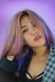 a woman with pink hair is posing for a picture