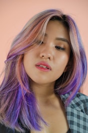 a woman with purple hair and a checkered shirt