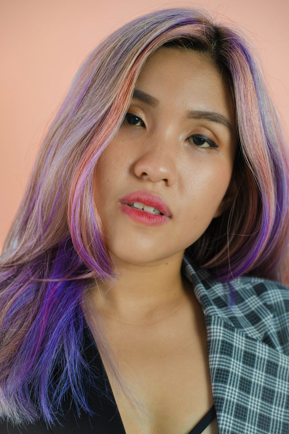 a woman with pink and purple hair posing for a picture