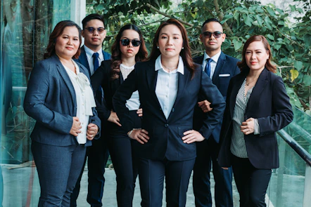a group of business people standing next to each other