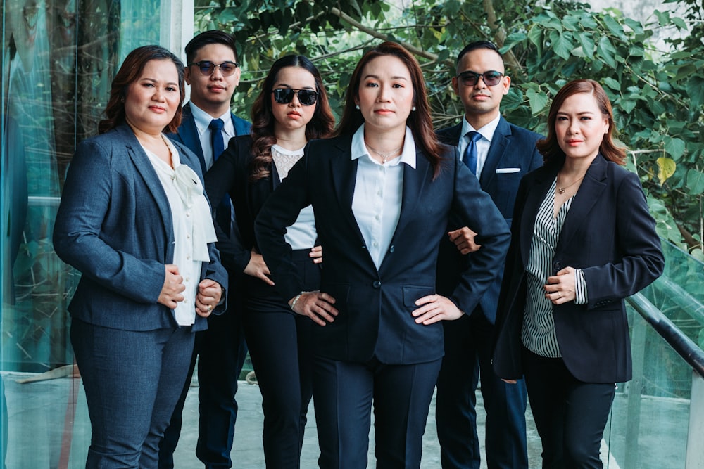 a group of business people standing next to each other