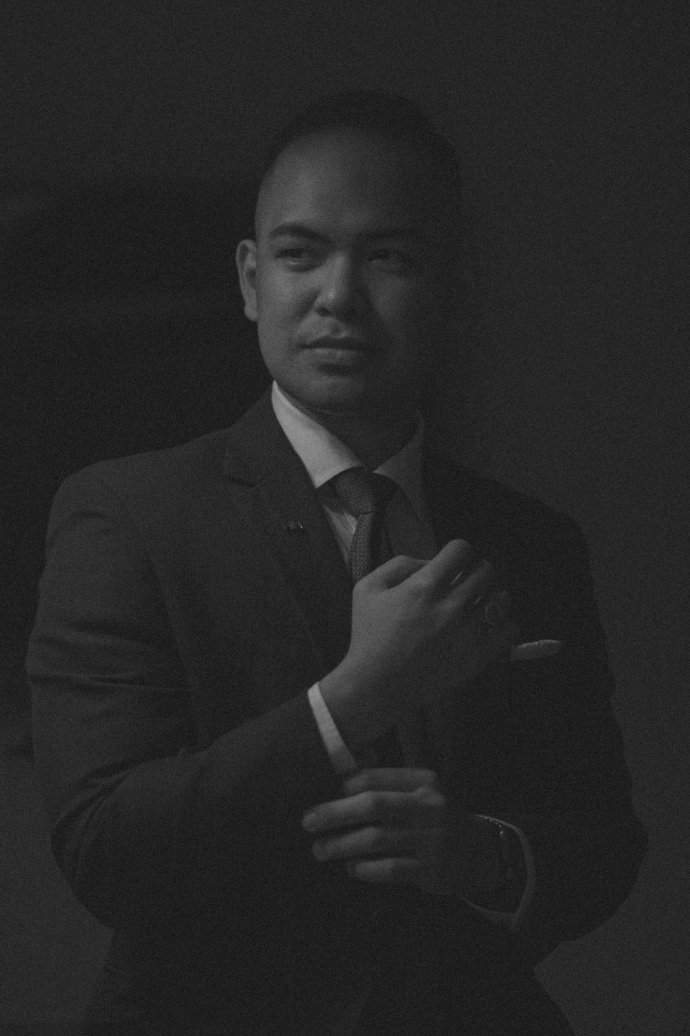 a black and white photo of a man in a suit