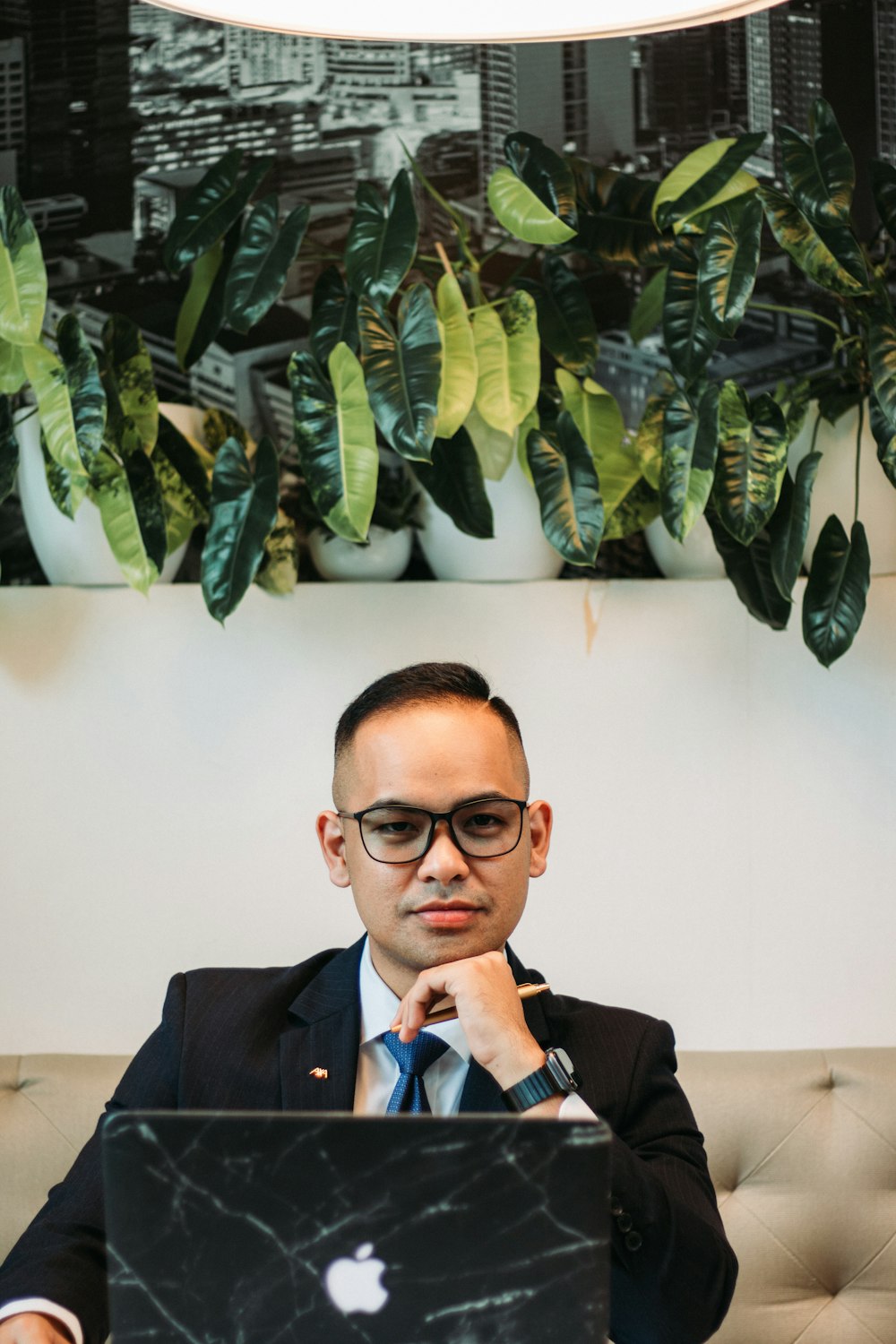 a man sitting at a table with a laptop in front of him