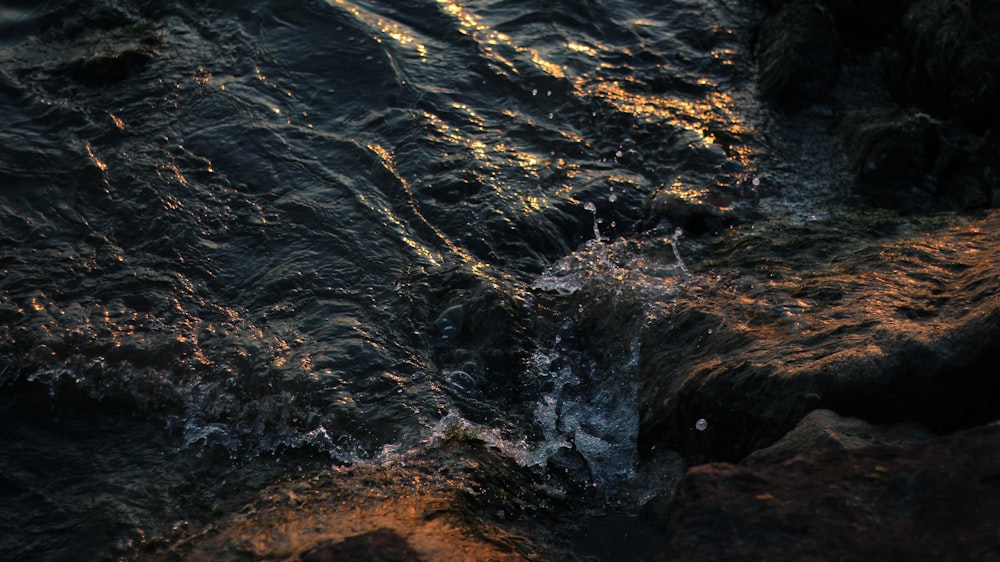 a close up of water on a rocky shore