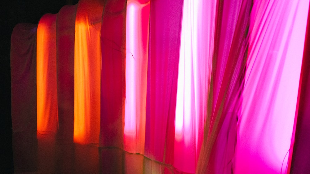 a row of curtains that are lit up in the dark