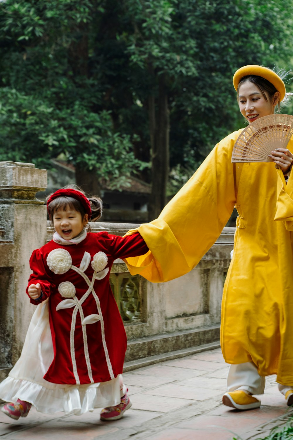 a woman and a child dressed in traditional chinese clothing