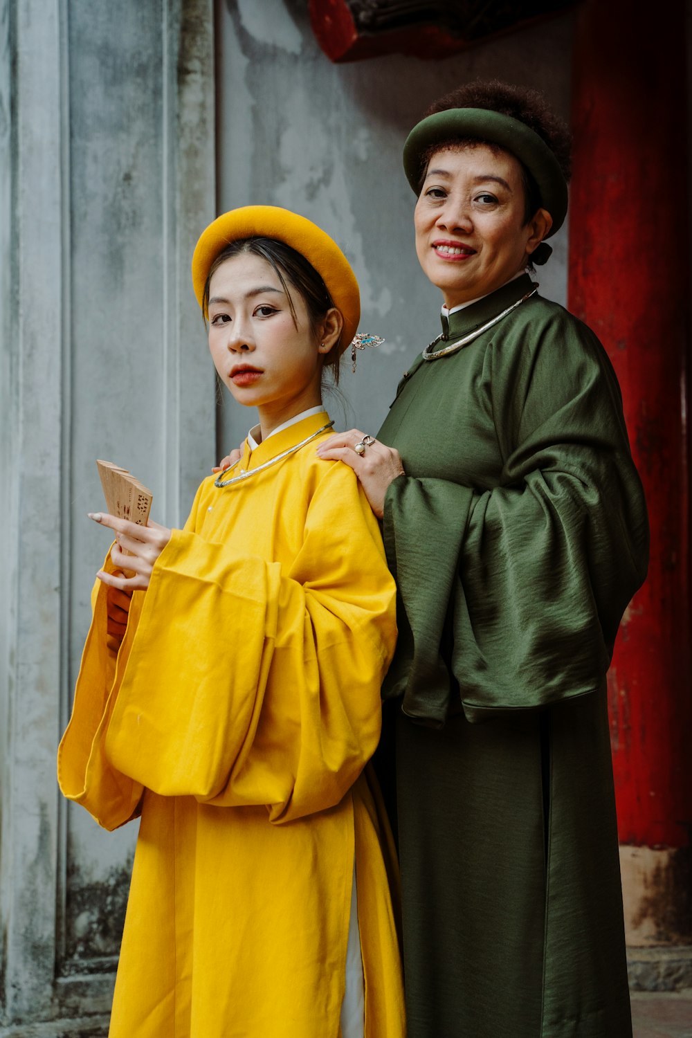 a woman in a yellow dress and a woman in a green dress