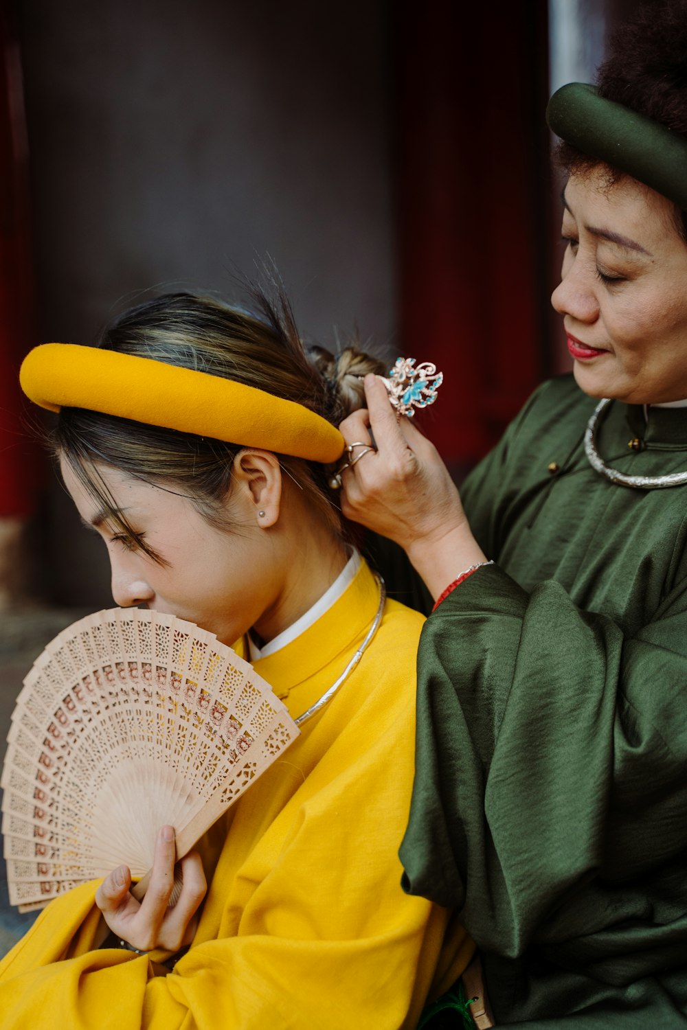 a woman is getting her hair combed by a woman