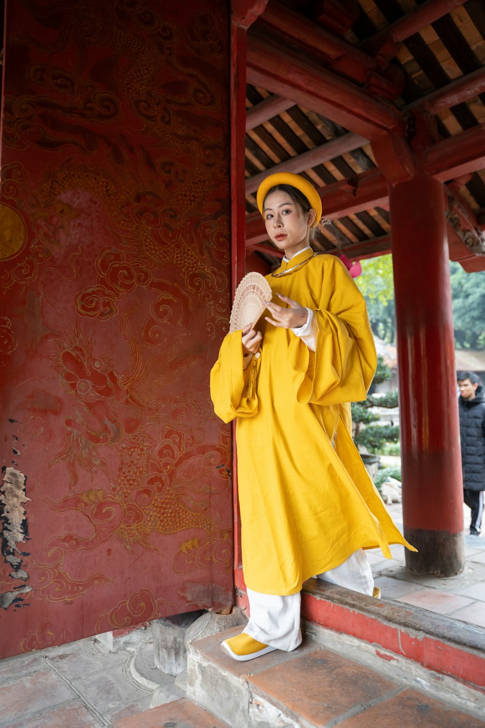 a woman in a yellow outfit is standing outside