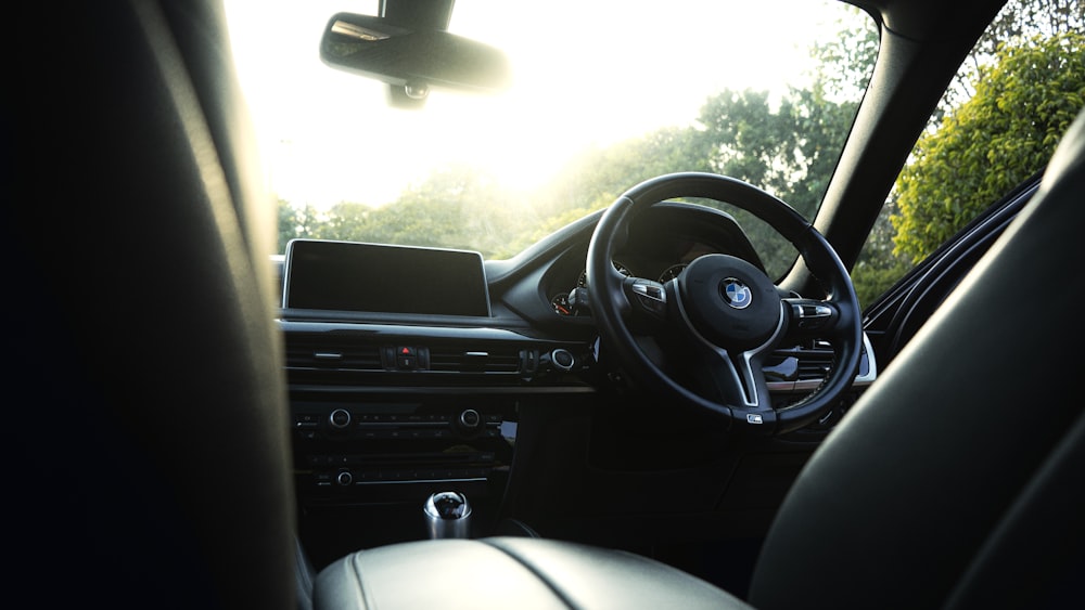 the interior of a car with the sun shining through the windshield