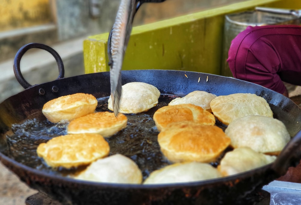 a frying pan filled with bread on top of a stove