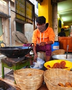 a man sitting in front of baskets of food
