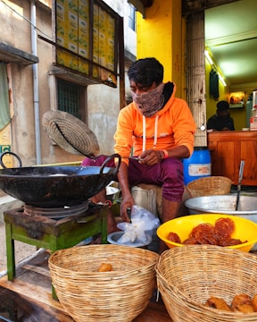 a man sitting in front of baskets of food
