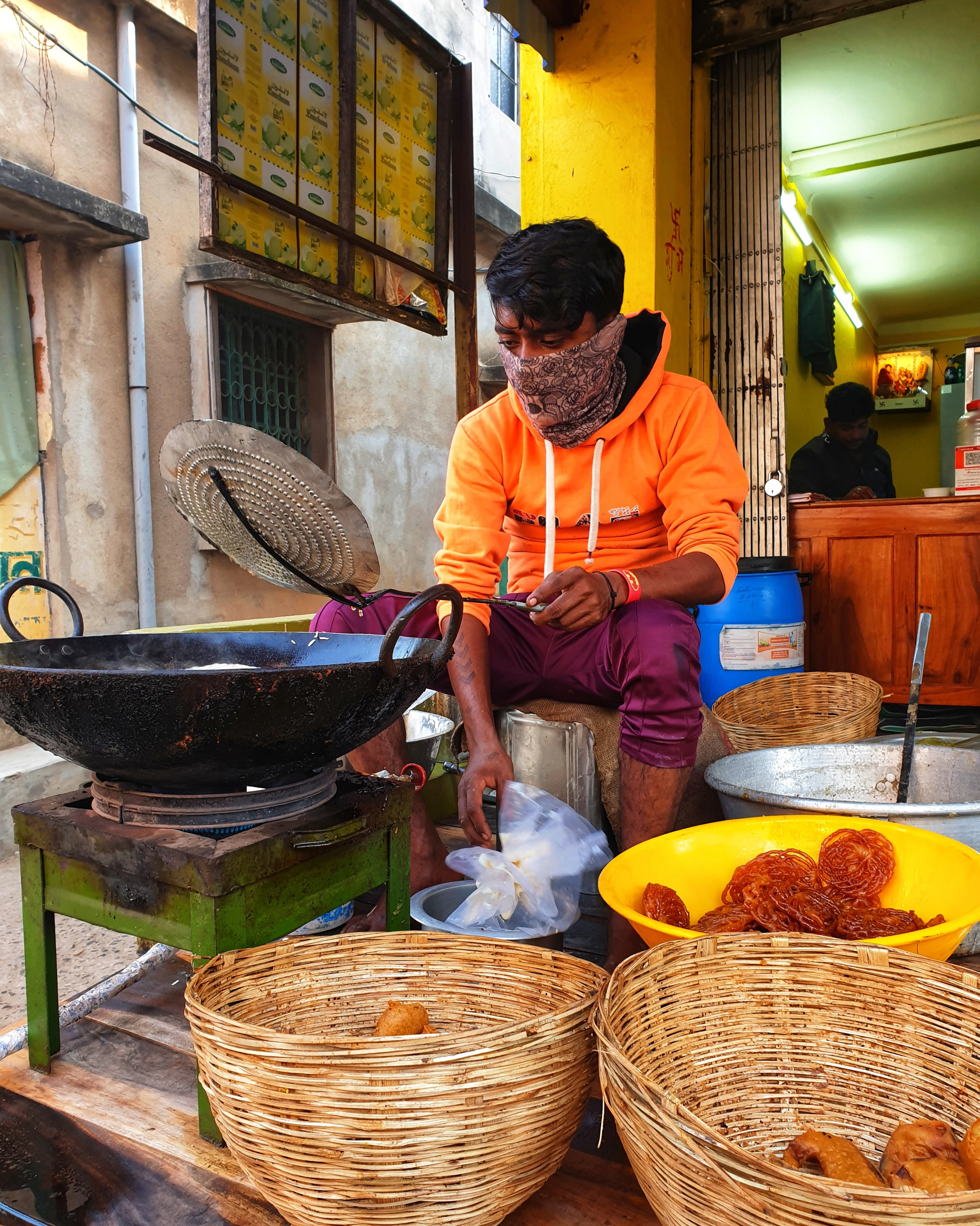 A cook working a wok of chillies at a street stall in Varanasi
