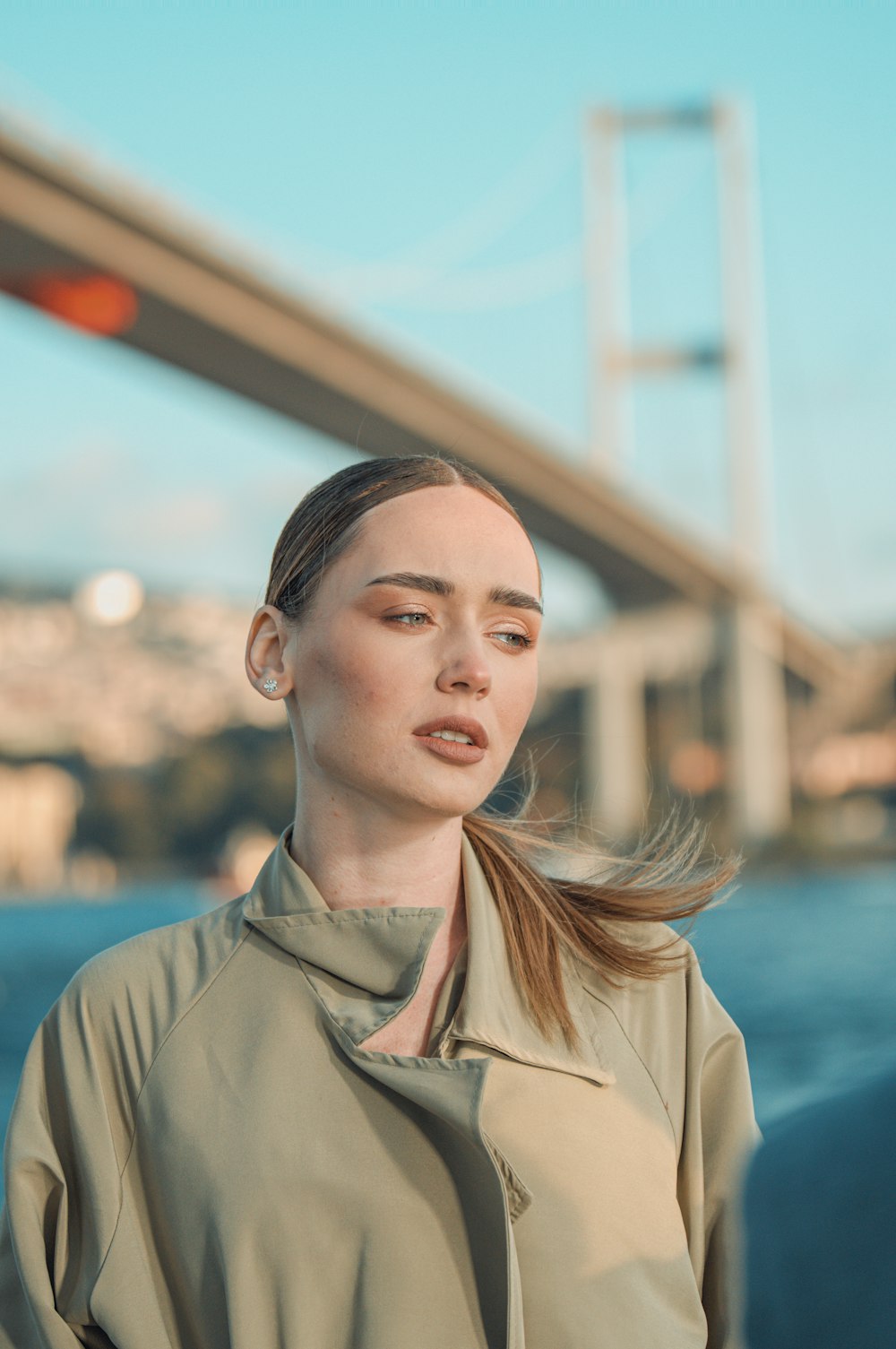 a woman standing in front of a bridge