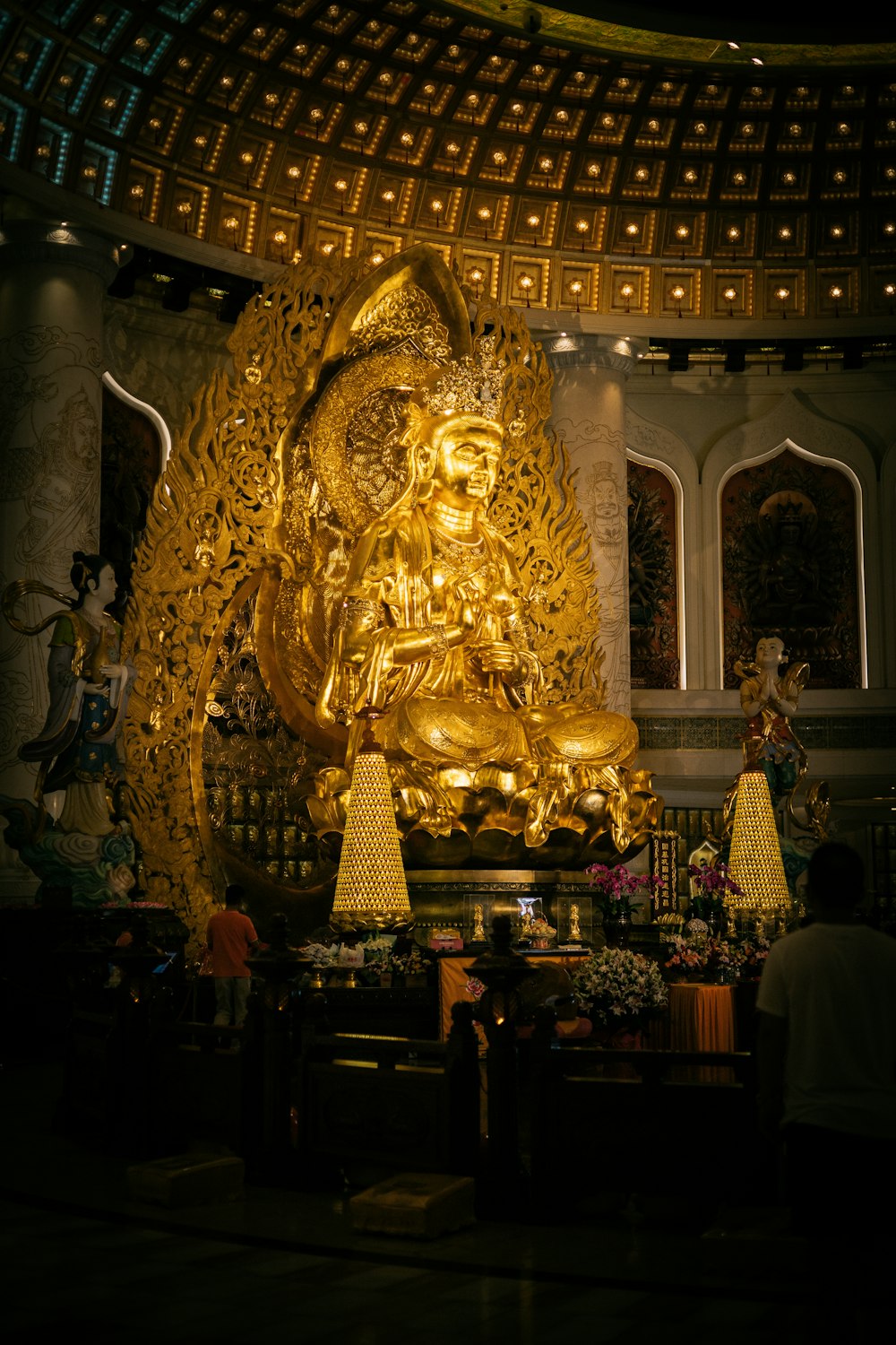 a large golden buddha statue in a room